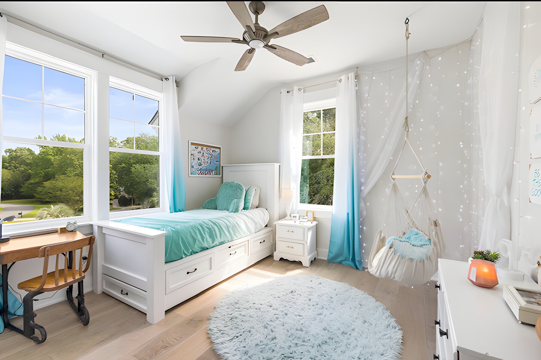 Bright kids' bedroom with bay windows and hammock chair