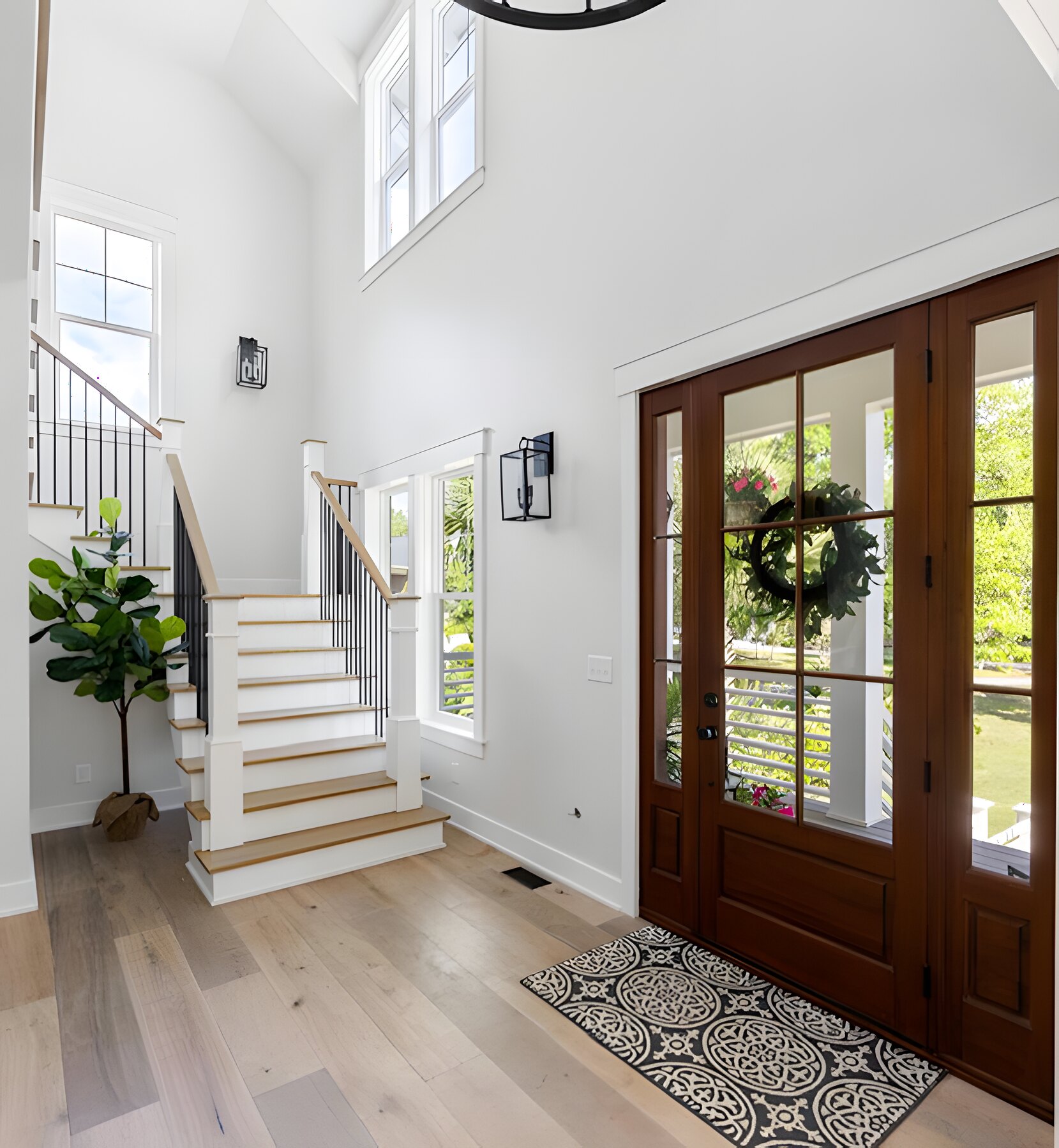 Two-story foyer with mahogany door and white oak staircase