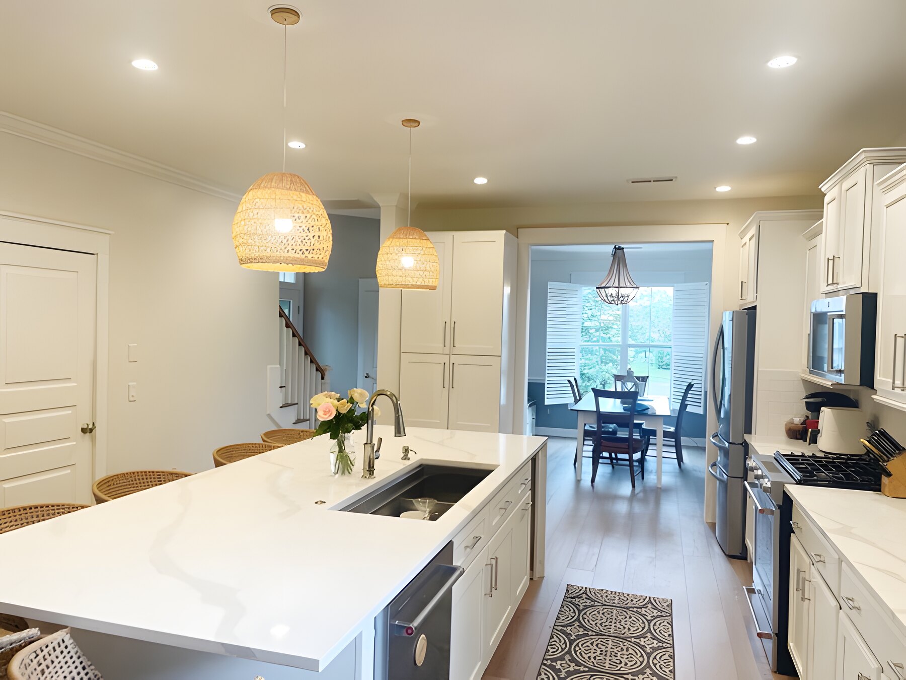 Quartz island kitchen open to a banquette dining nook