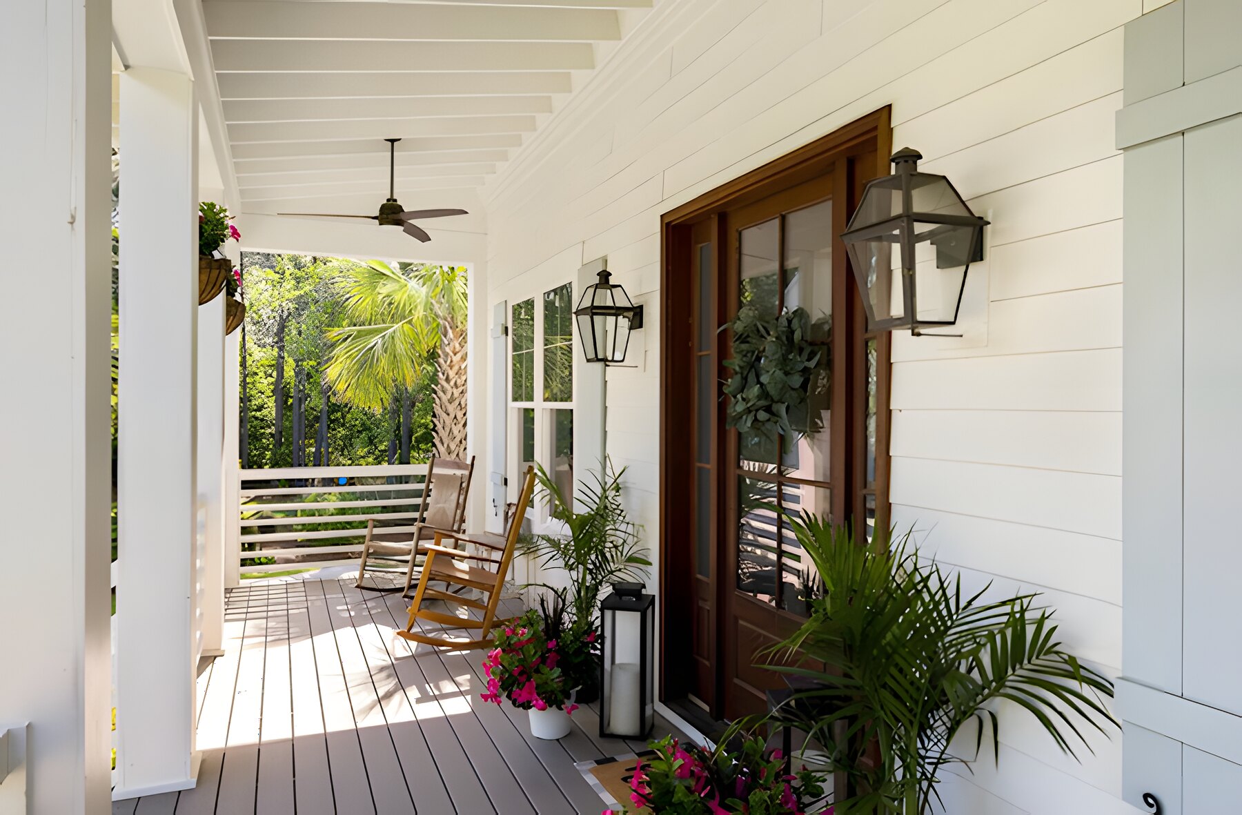 Front porch with rocking chairs, lanterns, and a mahogany door